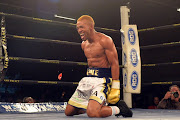 Azinga Fuzile celebrates after knocking down Tshifhiwa Munyai during the Four go to War boxing bout at Emperors Palace on October 21, 2017 in Johannesburg, South Africa.