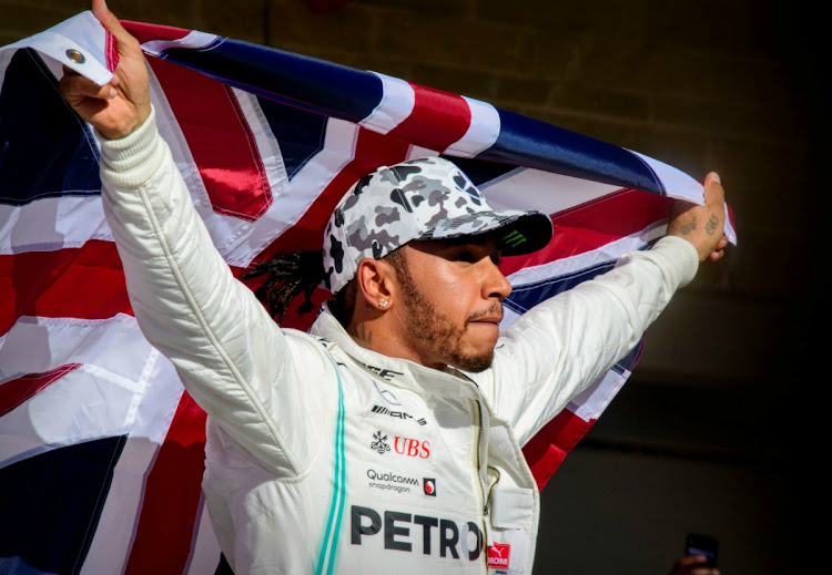 Mercedes AMG Petronas Motorsport driver Lewis Hamilton (44) of Great Britain holds up the Union Jack as he celebrates winning his sixth world championship after he finishes in second place in the United States Grand Prix at Circuit of the Americas. Picture: TPX IMAGES OF THE DAY/JEROME MIRON