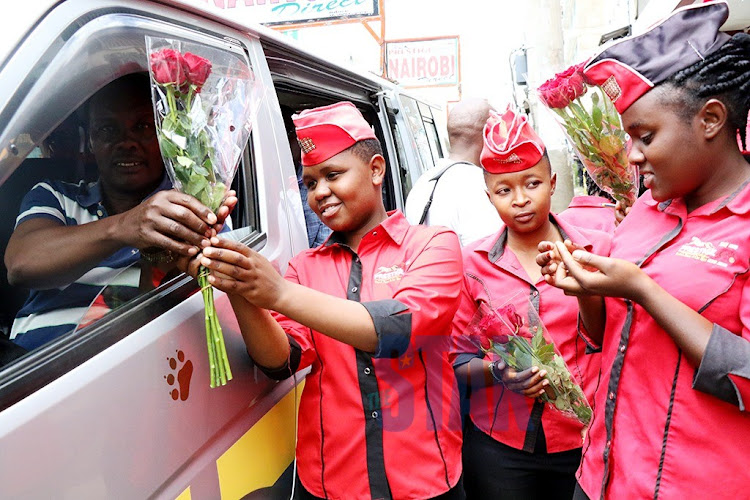 From left Jacinta Njeri,Jecinta Wangare, Tabitha kerubo and Dorcas Kanyigi all Matatu hostesses working for Prestige shuttle Matatus in Nakuru, give free flowers to travelers to mark the valentine day yesterday.