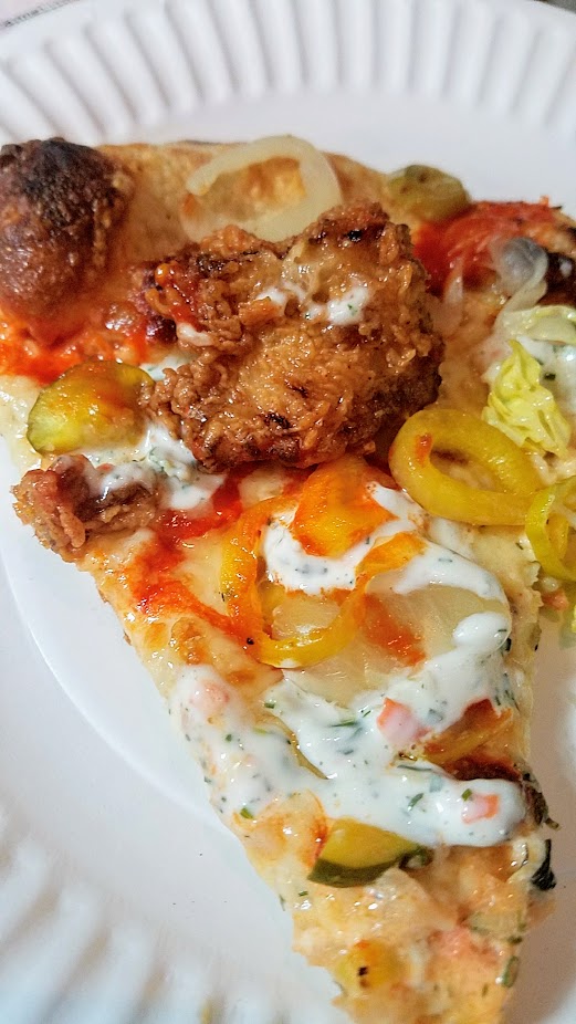 The Crown PDX Imperial specialty pizza with fried chicken, pickles, ranch, honey, hot sauce