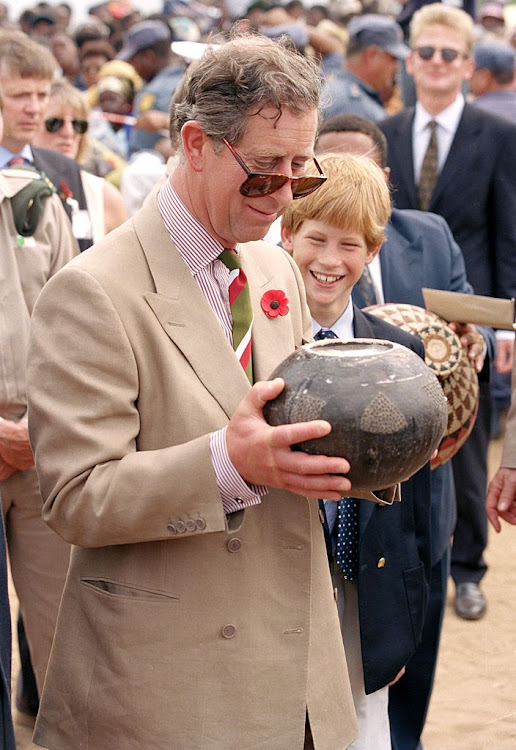 Prince Harry's father samples traditional African beer in Dukuduku, KwaZulu-Natal in 1997.