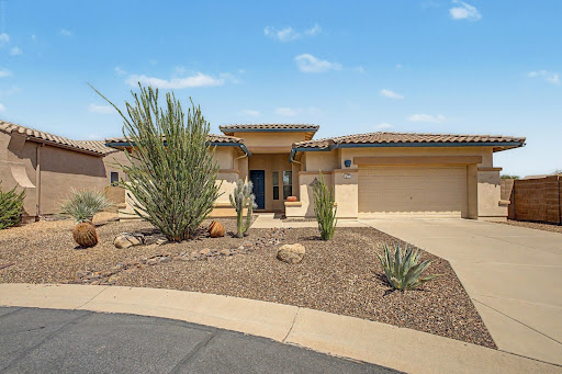 Front beige house, desert garden, blue sky in this luxury house for sale in Gold Canyon ($499,900)
