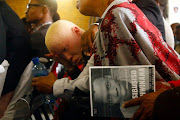 A distraught Tebatso Mashishi, Sibusiso Khwinana's Matwetwe costar, who was also with Khwinana when he was stabbed to death sits among other mourners at Khwinana's funeral on Saturday. 