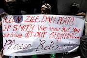 Refugees demonstrate outside the Cape Town high court on January 28 2020. They are demanding help  to move to another country. 