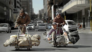 Frank Solomon surfs the streets of Johannesburg with Thabo Mouti, left, and Mokete Mokete.