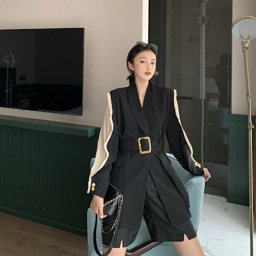 Title 4, Suit with a waist belt, designed to create a fl...