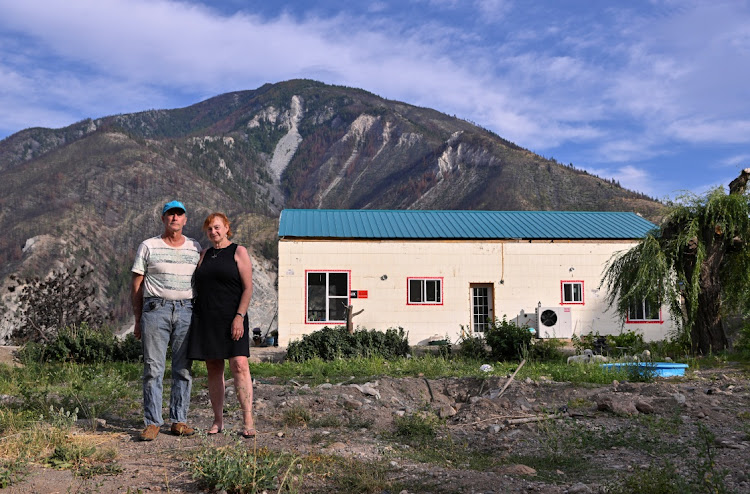 Tricia Thorpe and her husband Don Glasgow stand outside of their new home, a year after a wildfire entirely destroyed the western Canadian village of Lytton, British Columbia, Canada, July 24 2022. Picture: REUTERS/JENNIFER GAUTHIER