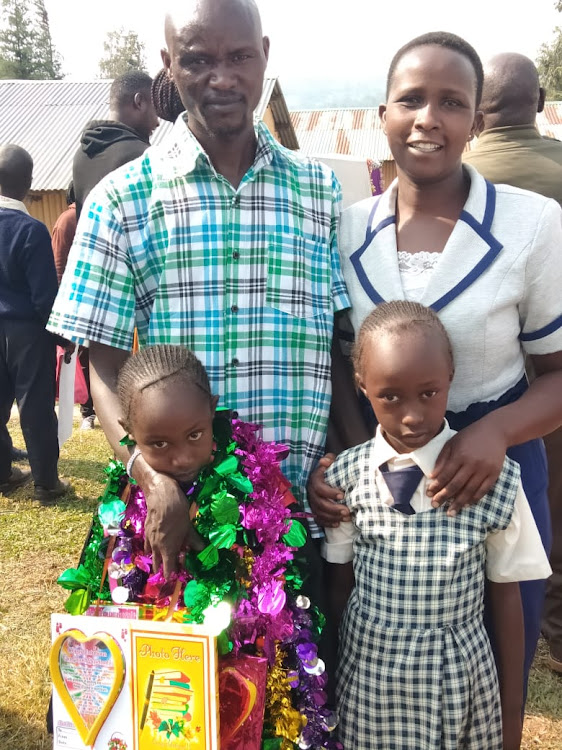 Abraham Tarbei, his wife Clara and daughters Golden Victory Cherop (L) and Joy Jepchirchir