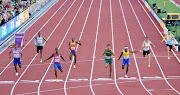 Champion Allison of the US crosses the line to win the semifinal ahead of Wayde van Niekerk and Barbados' Jonathan Jones, to the South African's left.