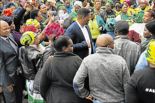 FULL SUPPORT: Pumlani Mkolo is surrounded by his supporters outside the East London Magistrate’s Court Picture: ZWANGA MUKHUTHU