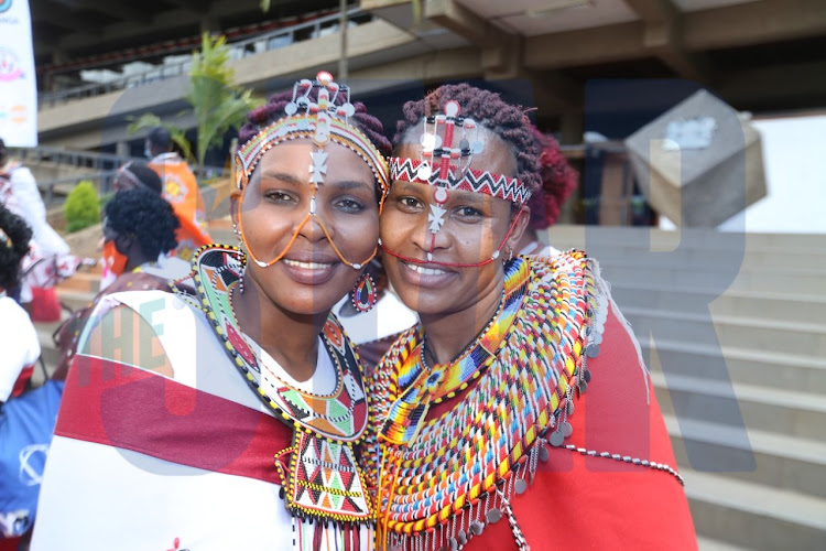 Susan Letinina (L) and Lucy Lerugum display some of the maasai bead work on them during the official launch of the Johari Beads bracelet on December 6, 2021.