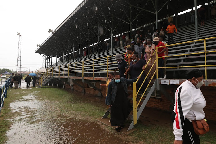 Parents leave the venue after rain washed out a meeting with Gauteng education MEC Penaza Lesufi on February 17 2022 at Hoerskool Jan Viljoen, Randfontein, west of Johannesburg.