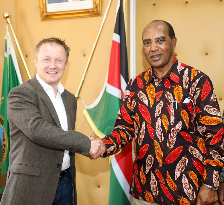 Nyandarua Governor, Francis Kimemia confers with Simplifine President, Steve Carlyon at his office in Ol-Kalou. Simplifine which is a food processor has contracted potato farmers in the county to grow and supply premium potato varieties for fast food chains and export market.