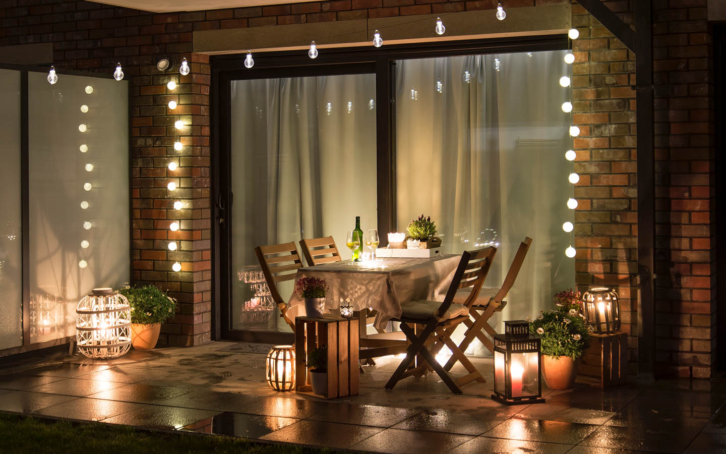 outdoor lighting setup with seating arrangement and table