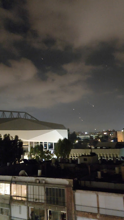 Objects are seen in the sky above Tel Aviv after Iran launched drones and missiles towards Israel, in Tel Aviv, Israel April 14, 2024, in this screen grab obtained from a social media video. Picture: SEMYON GALPERIN