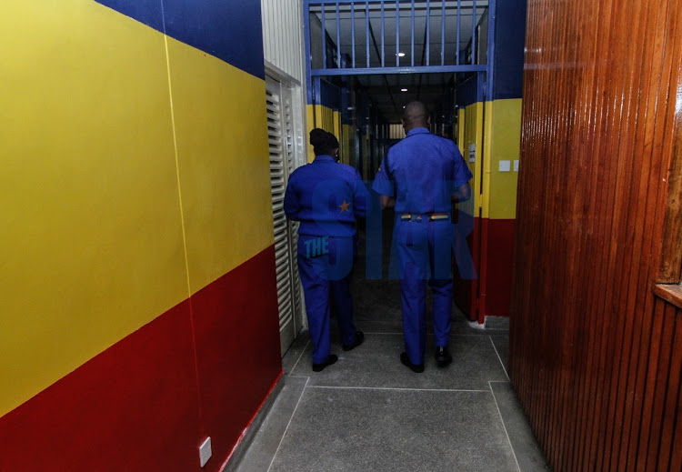 Police officers based at the Milimani law Courts walk along the Corridors of the newly set Judiciary Police Unit at the former Forodha house on September 13,2021.