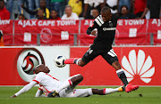 Thabiso Kutumela of Orlando Pirates gets away from a tackle by Siyanda Zwane of Ajax Cape Town during the Absa Premiership match at Cape Town Stadium, Cape Town on January 31 2018. 