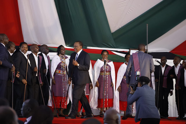 President Uhuru Kenyatta joins a choir at the 2019 National Prayer Breakfast meeting.