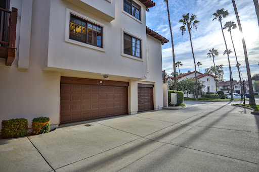 building facade with garage and palm trees in this luxury house for sale in Glendora ($850,000)