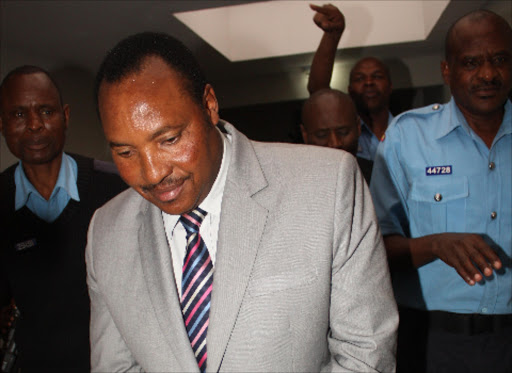 BAILLED: Embakasi MP Ferdinand Waititu being led to cells at Milimani court yesterday. He has been released on bail pending the hearing of his case in November. Photo/Philip Kamakya