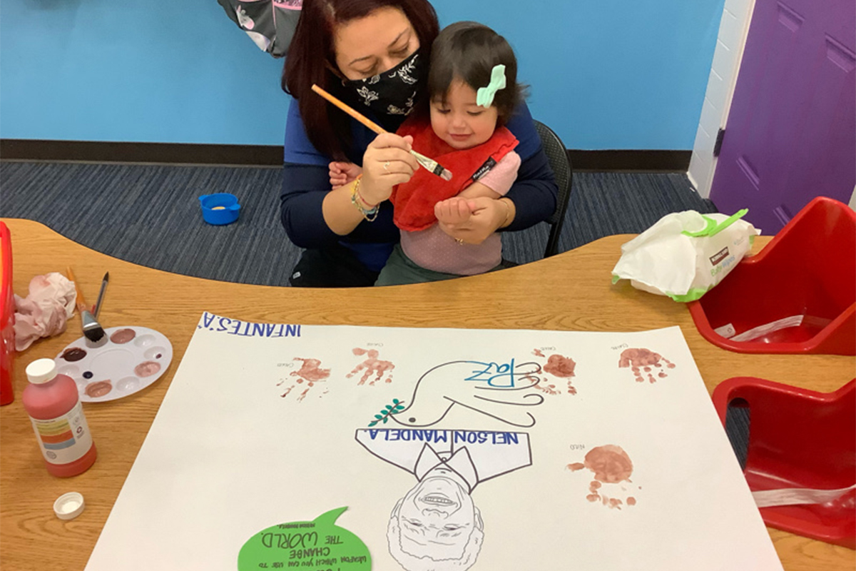 teacher with infant doing a project for nelson mandela day