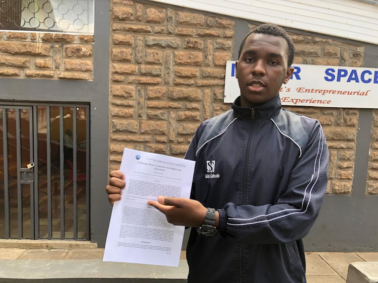 Walter Mchana holds a copy of his journal, which received global recognition, during an interview with the Star at Makini Cambridge School, Ngong Road