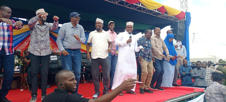 Defence CS Aden Duale and other leaders dance to a jig at Masalani stadium on Saturday.