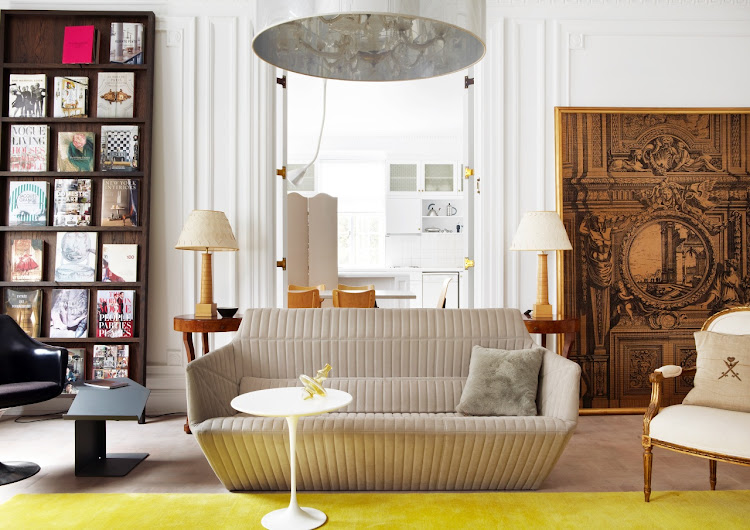 In the sitting room, on the left, an Oblique Bookshelf by Marcel Wanders for Moooi displays some of Green’s books on couture. Other contemporary pieces such as Konstantin Grcic’s Diana sheet-metal table for Classicon rub shoulders with Eero Saarinen’s Tulip table and armchair for Vitra. They are balanced on the far side of the Facet Sofa by the Bouroullec brothers for Ligne Roset by a French gilt antique chair and tapestry.