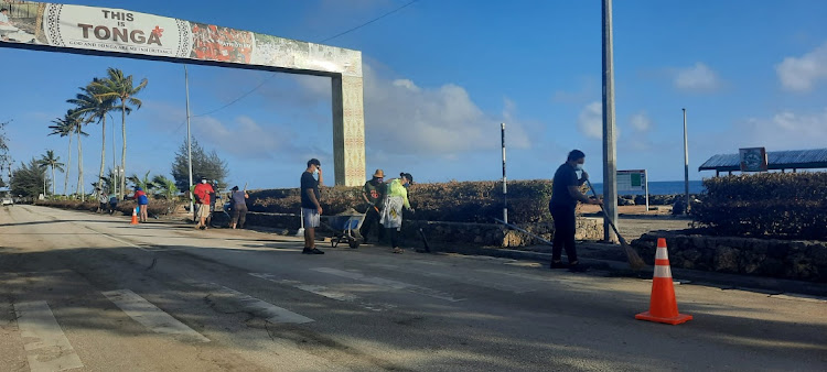 People clean debris following volcanic eruption and tsunami, in Nuku'alofa, Tonga, in this picture obtained from social media, January 20 2022. Picture: MARIAN KUPU/BROADCOM BROADCASTIN/REUTERS