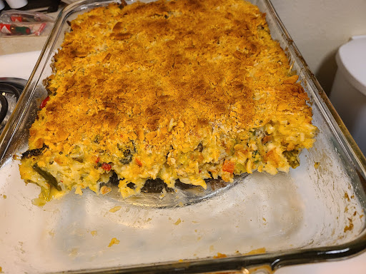 Baking dish stove on stove with a portion of casserole removed