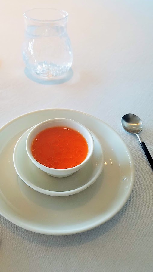 Lobster, Goat Milk, Juice from Fermented Carrots and Sea Buckthorn appetizer at Geranium, a three Michelin star restaurant in Copenhagen