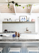 Baby blue cabinets topped with concrete tops made by Damian Oliveri make the heart of the home a show-stopping one.