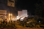 Heavy machinery being used to clear mounds of debris from fallen buildings in the city of Adıyaman in Türkiye 