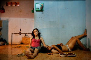 1st Prize Contemporary Issues Stories<br />
<br />
foto: © Maika Elan, Vietnam, Most<br />
The Pink Choice, Vietnam <br />
<br />
22 June 2012, Da Nang, Vietnam<br />
Phan Thi Thuy Vy and Dang Thi Bich Bay, who have been together for one year, watch television to relax after studying at school.<br />
Vietnam has historically been unwelcoming to same-sex relationships. But its Communist government is considering recognizing same-sex marriage, a move that would make it the first Asian country to do so, despite past human rights issues and a long-standing stigma.<br />
In August 2012, the country’s first public gay pride parade took place in Hanoi.