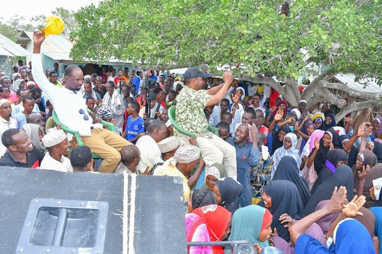 Garissa governor aspirant Dekow Mohamed with his running mate Abdi Amin are carried by their supporters in Masalani town on Tuesday, May 17.