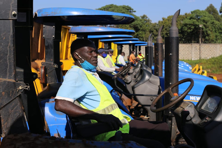 Drivers test the tractors bought by West Kenya to transport cane from contracted farmers