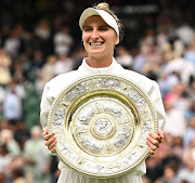 Czech Republic's Marketa Vondrousova celebrates with the trophy winning her final match against Tunisia’s Ons Jabeur.