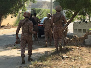 Paramilitary forces and police are seen during an attack on the Chinese consulate, where blasts and shots are heard, in Karachi, Pakistan November 23, 2018. 