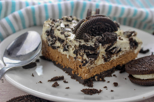 A slice of Oreo no-bake chocolate cheesecake bars on a plate.