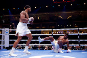 Anthony Joshua knocks down Francis Ngannou. 