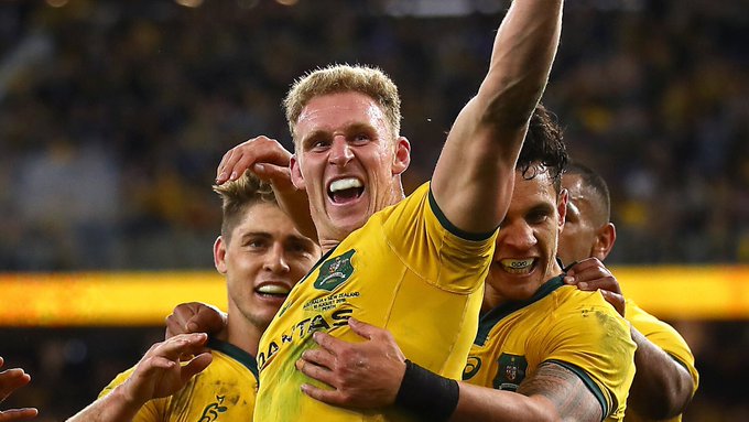 Reece Hodge celebrates with teammates after scoring his second try.