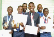 MAGIC FEET: Leeds United's top scorers and players Julius Makau, Tumiso Moreoa, Itumeleng Mphahlele and Samuel Malete flanked by the founders of the club, Edwin Ribane and Thabo Maponya. Pic. Edwin Hlongwane. © Unknown.