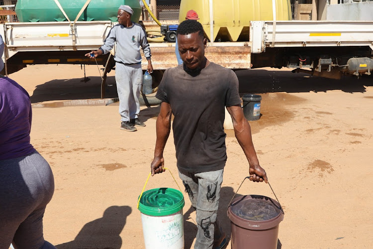 Residents in Temba , Hammanskraal collecting water from water tanks in the area.