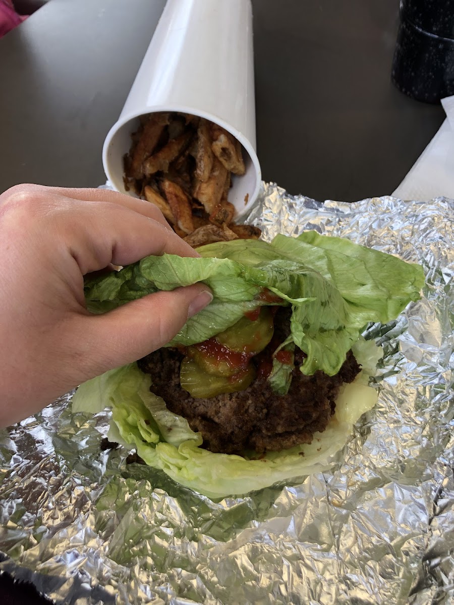 Lettuce wrapped burger with two patties, as well as tons of fries