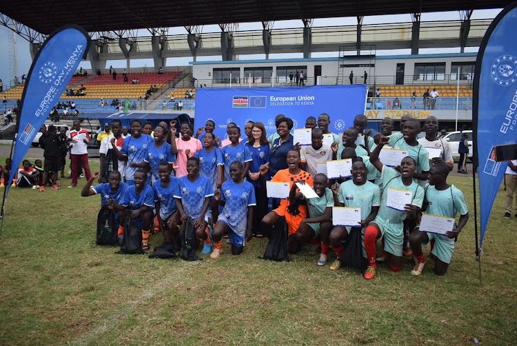 European Union Ambassador to Kenya Henriette Geiger and Homa Bay Governor Gladys Wanga with winners Kobala Girls and Ringa Boys at Raila Odinga Stadium in Homa Bay town on April 7,2024