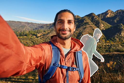 Young man editing a photo crasher out of a selfie he took while hiking a mountain landscape.