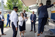 US Deputy Attorney General Lisa Monaco chats with DC Police Chief Robert Contee before touring an Alcohol, Tobacco and Firearms (ATF) crime gun intelligence mobile command center (MCC), which provides investigators with ballistic processing at crime scenes, after the announcement of the launch of the Justice Department's five cross-jurisdictional gun trafficking strike forces at the ATF in Washington, DC, US, July 22, 2021.  