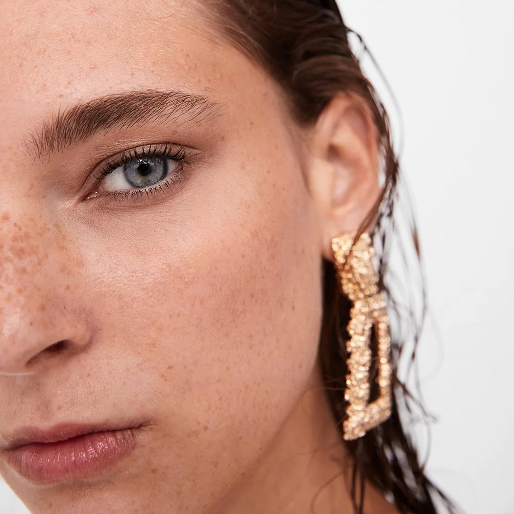 Title 1, Exaggerated geometric metal earrings. Make a st...