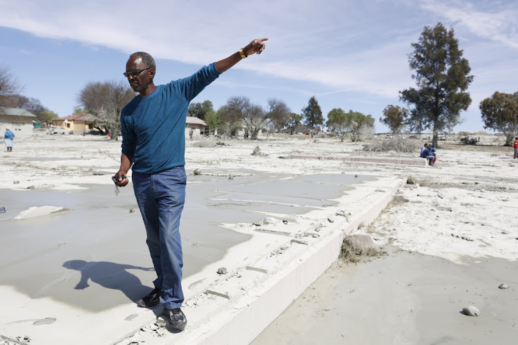 Wonder Mabula stands on the foundation where his house used to be.