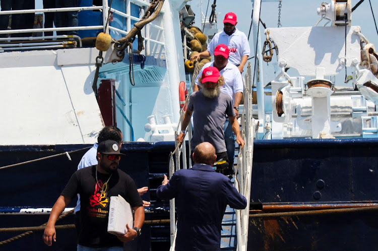 Australian sailor Timothy Lindsay Shaddock, 54, walks down the stairs of the Mexican tuna trawler where he was rescued along with his dog Bella after being adrift for over two months, in Manzanillo Mexico July 18, 2023.